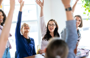women raising their hands